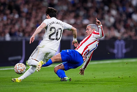 Atletico Madrid's Antoine Griezmann, right, and Real Madrid's Fran Garcia challenge for the ball the Spanish La Liga soccer match between Real Madrid and Atletico Madrid in Madrid, Spain.