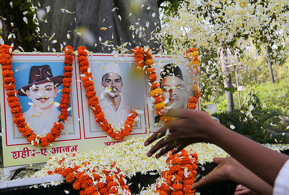 People pay floral tribute to freedom fighters Bhagat Singh, Sukhdev Thapar and Shivaram Rajguru on the 'Shaheed Diwas', or Martyrs' Day, in Prayagraj. - | Photo: PTI