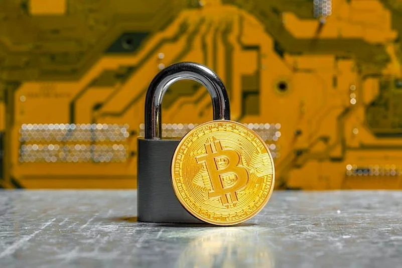 Bitcoin coin leaning on a lock for security