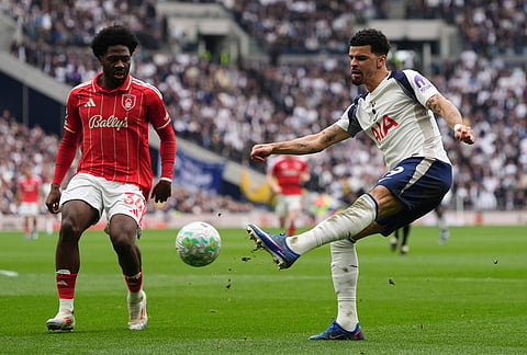 Tottenham Hotspur's Dominic Solanke, right, and Nottingham Forest's Ola Aina vie for the ball, during the English Premier League soccer match between Tottenham Hotspur and Nottingham Forest, in London.