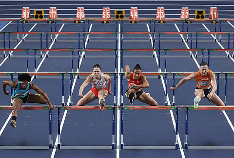 Devynne Charlton, of Bahamas, from left, Pia Skrzyszowska, of Poland, Ditaji Kambundji, of Switzerland, and Nadine Visser, of the Netherlands, compete in the women's 60 meters hurdles final at the World Athletics Indoor Championships in Torun, Poland.