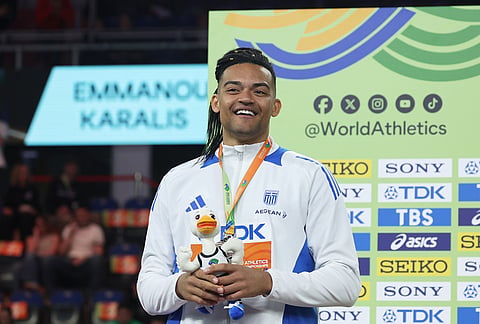 Silver medalist Emmanouil Karalis, of Greece, poses on the podium after winning the silver medal in the men's pole vault at the World Athletics Indoor Championships in Torun, Poland.