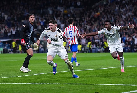 Real Madrid's Federico Valverde, second from left, celebrates after scoring his side's second goal the Spanish La Liga soccer match between Real Madrid and Atletico Madrid in Madrid, Spain.