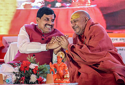 Madhya Pradesh Chief Minister Mohan Yadav, left, shares a light moment with spiritual leader Swami Yatindranand Giri during the inauguration of Jeevan Deep Ashram, at Vrindavan, in Mathura district.