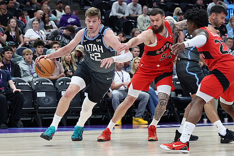 Utah Jazz forward Kyle Filipowski (22) drives to the basket against Toronto Raptors forward Sandro Mamukelashvili (54) during the first half of an NBA basketball game in Salt Lake City.