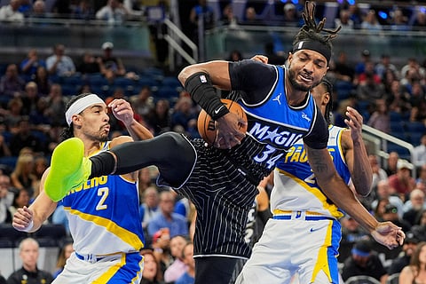 Orlando Magic center Wendell Carter Jr. (34) grabs a rebound in front of Indiana Pacers guard Andrew Nembhard (2) and guard Aaron Nesmith during the first half of an NBA basketball game in Orlando, Fla.