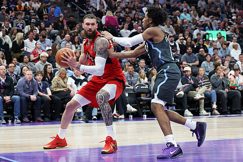 Toronto Raptors forward Sandro Mamukelashvili, left, goes to the basket against Utah Jazz guard Andersson Garcia, right, during the second half of an NBA basketball game in Salt Lake City.