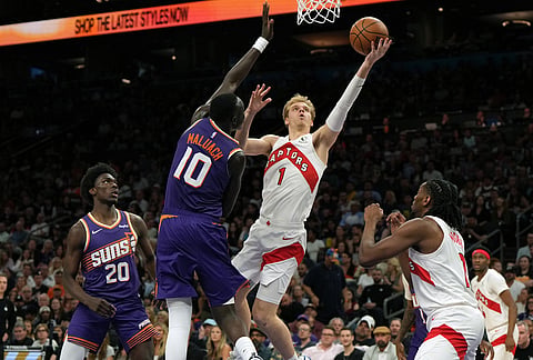 Toronto Raptors guard Gradey Dick (1) shoots over Phoenix Suns center Khaman Maluach (10) during the second half of an NBA basketball game in Phoenix. 