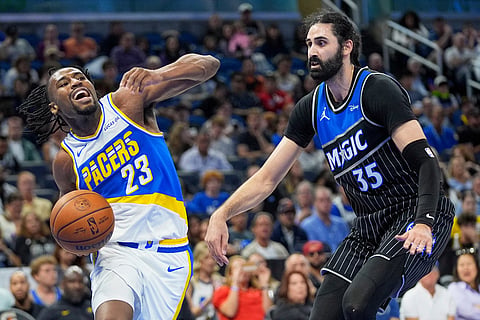 Indiana Pacers guard Aaron Nesmith (23) drives past Orlando Magic center Goga Bitadze (35) during the second half of an NBA basketball game in Orlando, Fla.