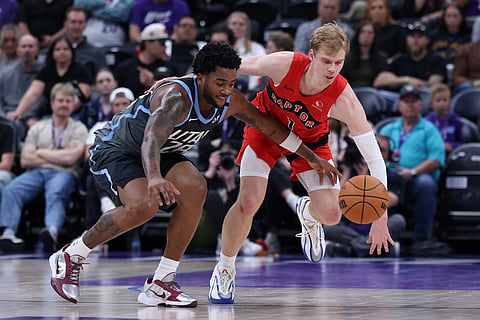 Utah Jazz forward Brice Sensabaugh, left, and Toronto Raptors guard Gradey Dick go for the ball during the second half of an NBA basketball game in Salt Lake City.