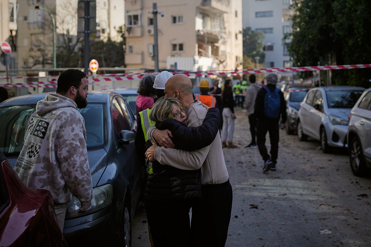  People react at the site of an Iranian missile strike in Tel Aviv, Israel, Tuesday, March 24, 2026.  - AP Photo/Ohad Zwigenberg