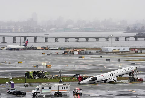 An Air Canada jet and Port Authority fire truck sit on the runway at LaGuardia Airport, after colliding with each other after the jet landed Sunday night in New York. 