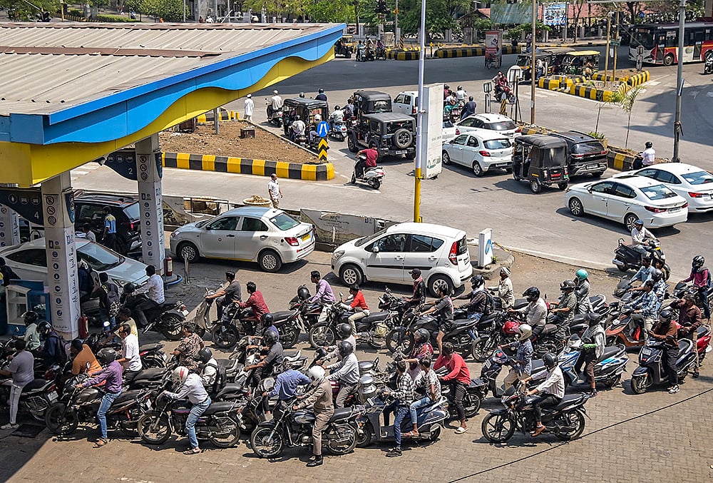 People wait in long queues at a gas station amid rumours of a fuel shortage in the wake of the West Asia conflict, in Nagpur. - PTI