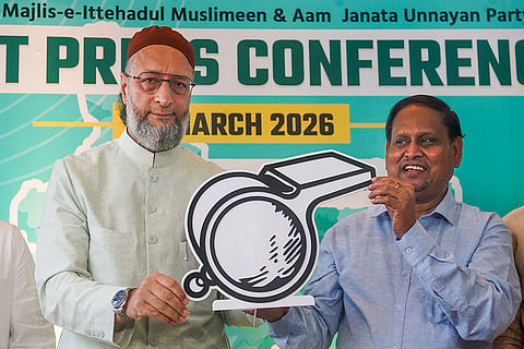 All India Majlis-e-Ittehadul Muslimeen (AIMIM) President Asaduddin Owaisi, left, and Aam Janata Unnayan Party (AJUP) Chief Humayun Kabir release their alliance symbol during a press conference, in Kolkata.
