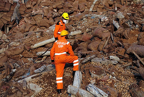 State Disaster Response Force (SDRF) personnel conduct a rescue operation after a portion of a cold storage facility collapsed on Monday, which also triggered an ammonia gas leak, in Prayagraj.