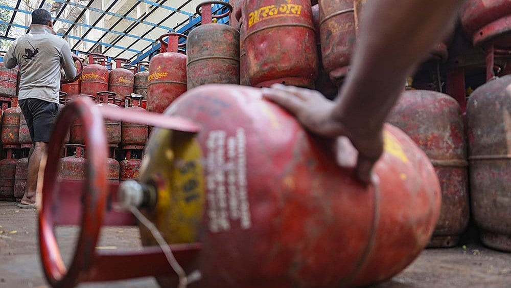 | Photo: PTI/Kunal Patil : A worker loads cooking gas cylinders onto a delivery truck amid LPG supply disruptions, in Mumbai.