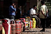 LPG Crisis: Now The Queue Waits For Fire | Photo: PTI : People wait in a queue with empty LPG cooking gas cylinders to avail refilled ones amid the ongoing supply crisis, in Prayagraj.