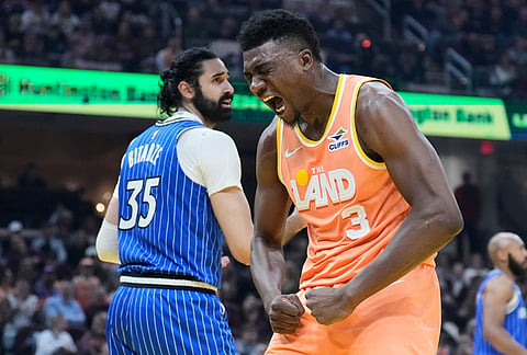 Cleveland Cavaliers center Thomas Bryant (3) shouts after dunking over Orlando Magic center Goga Bitadze (35) in the first half of an NBA basketball game in Cleveland.