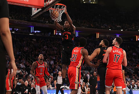 New York Knicks OG Anunoby (8) dunks the ball during the first half of an NBA basketball game against the New Orleans Pelicans, in New York.