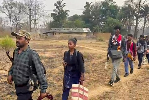 Senior Maoist commander Papa Rao, a member of the Dandakaranaya Special Zonal Committee (DKSZC) and in-charge of south Sub Zonal Bureau of Maoists, with his team members after their surrender, in Bijapur district, Chhattisgarh.