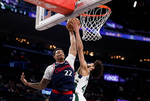 LA Clippers guard Jordan Miller (22) drives to the basket with the ball while being guarded by Milwaukee Bucks guard Andre Jackson Jr. (44) during the second half of an NBA basketball game in Inglewood, California.