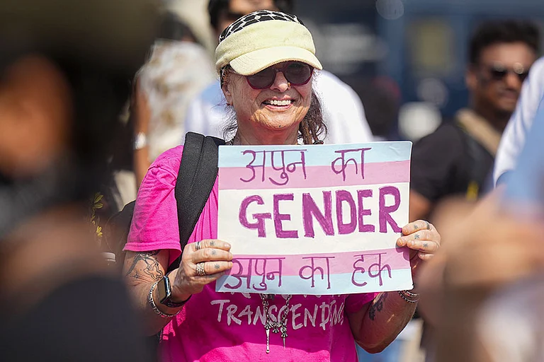 A member of the LGBTQIA+ community holds a placard during a protest against the passage of the Transgender Persons (Protection of Rights) Amendment Bill, 2026, in the Lok Sabha, at Azad Maidan, in Mumbai. - Photo: PTI/Shashank Parade