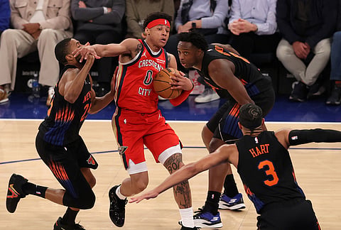 New Orleans Pelicans' Jeremiah Fears (0) drives to the basket against New York Knicks' Mikal Bridges (25), OG Anunoby (8) and Josh Hart (3) during the second half of an NBA basketball game in New York. 