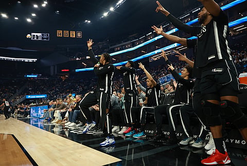 The Brooklyn Nets bench celebrates during the first half of an NBA basketball game against the Golden State Warriors in San Francisco.