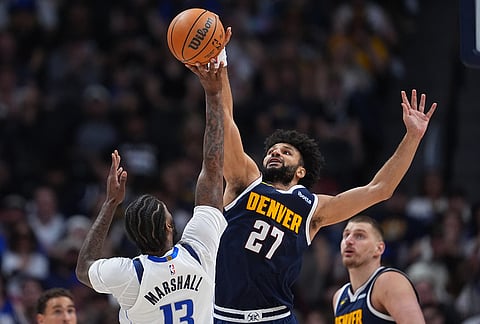 Denver Nuggets guard Jamal Murray (27) blocks a shot by Dallas Mavericks forward Naji Marshall in the second half of an NBA basketball game in Denver.