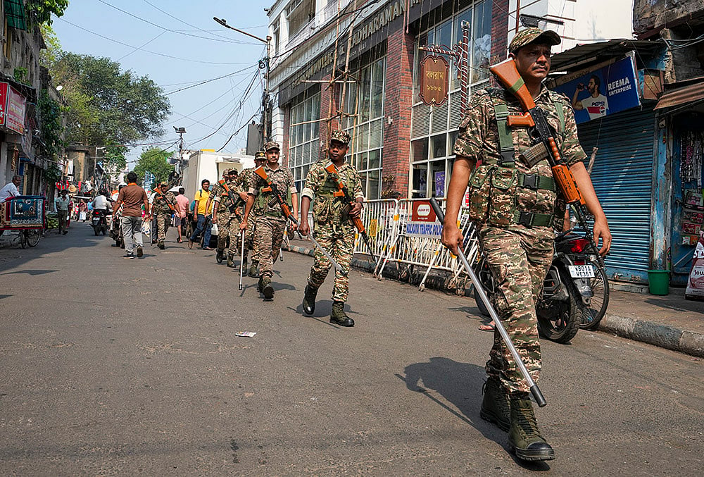 | Photo: PTI/Swapan Mahapatra : Security personnel keep vigil during a religious procession to mark the 'Ram Navami' festival, in Kolkata, West Bengal.
