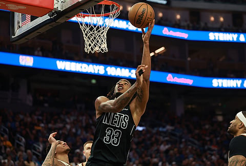 Brooklyn Nets center Nic Claxton (33) shoots against Golden State Warriors guard Will Richard, left, during the first half of an NBA basketball game in San Francisco.