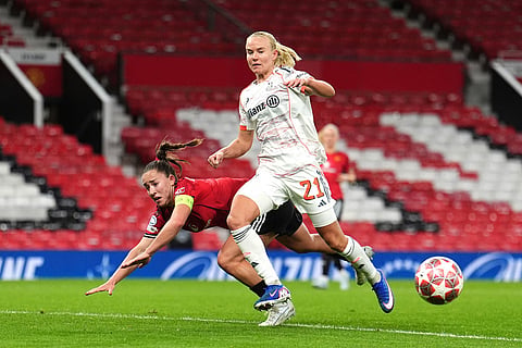 Manchester United's Maya Le Tissier, left, heads the ball clear from Bayern Munich's Pernille Harder during the Women's Champions League match between Manchester United and Bayern Munich in Manchester, England.