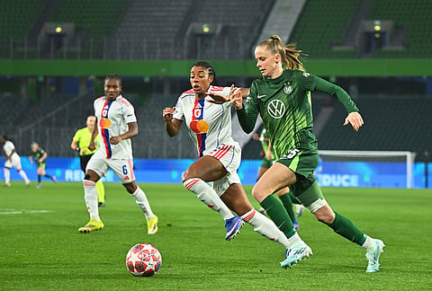 Wolfburg's Vivien Endemann, right, dribbles past Lyon's Vivien Endemann during their Champions League quarter-finals, first leg soccer match in Wolfsburg, Germany.