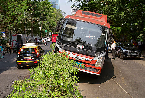 A Brihanmumbai Electric Supply and Transport (BEST) bus mounts a divider after the driver loses control, in the Kamala Mills area of Mumbai.