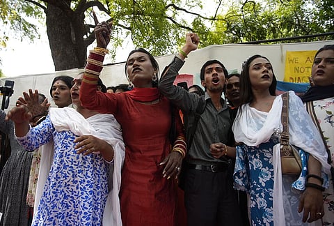 Supporters of the LGBTQIA+ community hold placards during a protest against the passage of the Transgender Persons (Protection of Rights) Amendment Bill, 2026, at Jantar Mantar in New Delhi.