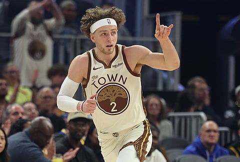 Golden State Warriors guard Brandin Podziemski (2) celebrates after scoring during the first half of an NBA basketball game against the Brooklyn Nets in San Francisco.