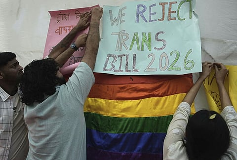 Supporters of the LGBTQIA+ community hold placards during a protest against the passage of the Transgender Persons (Protection of Rights) Amendment Bill, 2026, at Jantar Mantar in New Delhi.