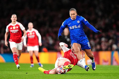 Arsenal's Lotte Wubben-Moy, bottom left, and Chelsea's Lauren James battle for the ball during the Women's Champions League soccer match between Arsenal and Chelsea in London.