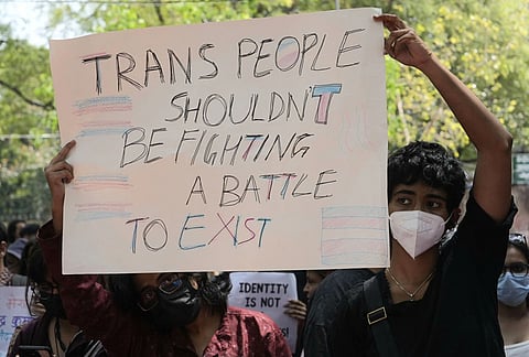 Supporters of the LGBTQIA+ community hold placards during a protest against the passage of the Transgender Persons (Protection of Rights) Amendment Bill, 2026, at Jantar Mantar in New Delhi.