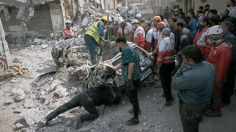 First responders inspect a destroyed car