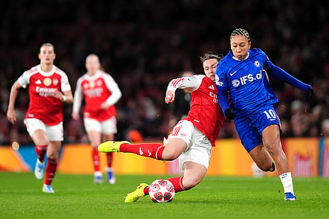 Arsenal's Lotte Wubben-Moy, left, and Chelsea's Lauren James battle for the ball during the Women's Champions League soccer match between Arsenal and Chelsea in London.