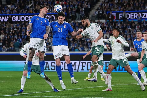 Italy's Matteo Politano, left, Italy's Alessandro Bastoni, second left, Northern Ireland's Brodie Spencer, center right, and Northern Ireland's Shea Charles vie for the ball during the World Cup qualifying play-off soccer match between Italy and Northern Ireland, in Bergamo, Italy.