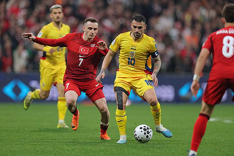 Romania's Nicolae Stanciu, right, fights for the ball with Turkey's Kerem Akturkoglu during the 2026 World Cup playoff semifinal soccer match between Turkey and Romania, in Istanbul, Turkey.