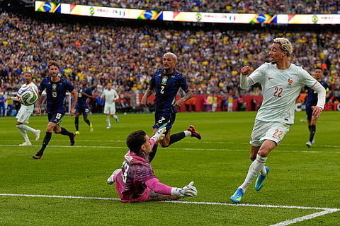 Hugo Ekitike of France scores his side's second goal past Brazilian goalkeeper Ederson during the international friendly soccer match between Brazil and France in Foxborough, Mass.