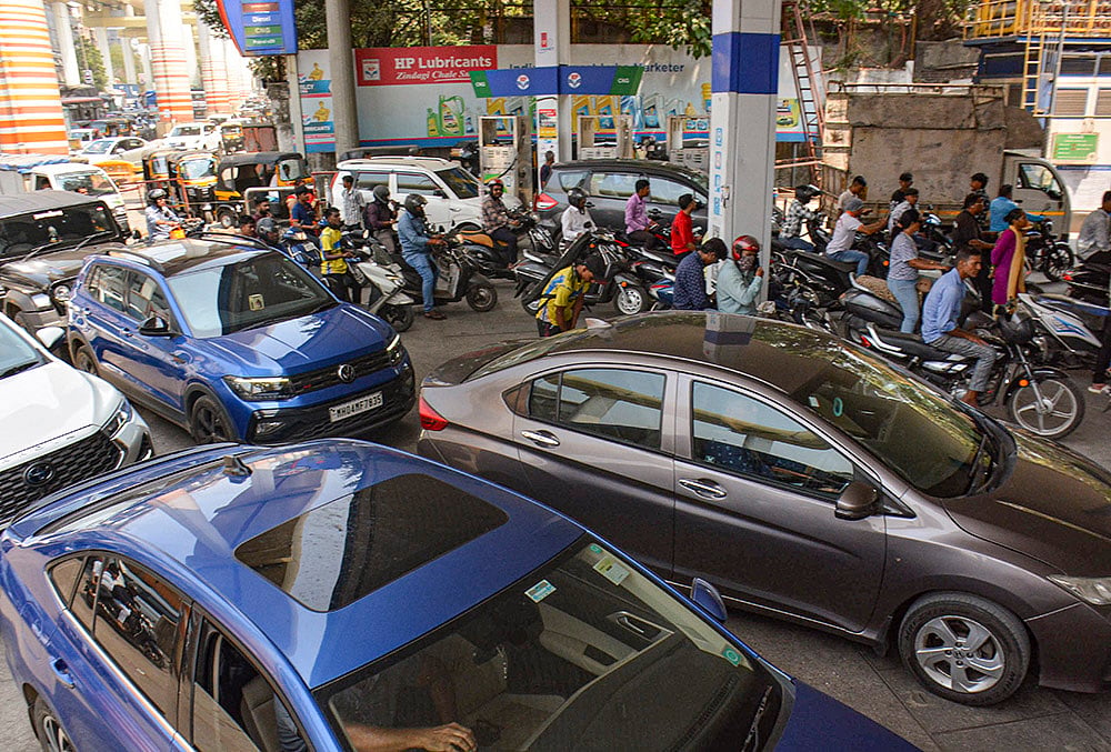 | Photo: PTI : Consumers throng at a petrol station amid rumours of fuel shortages due to the war in West Asia, in Thane. India has about 60 days of fuel stock cover, the government said on Thursday. 