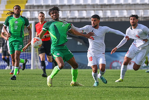 Iran's Mehdi Ghayedi, right, vies for the ball with Nigeria's Chibuike Nwaiwu during a friendly soccer match between Iran and Nigeria in Antalya, southern Turkey.