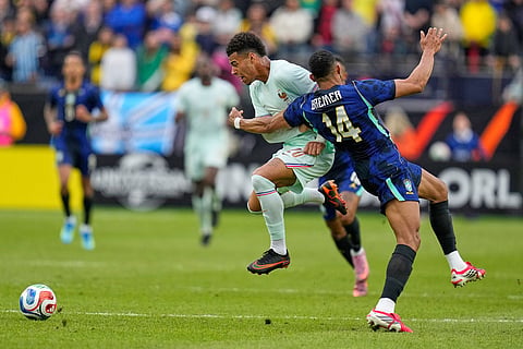 Desire Doue of France is fouled by Brazil's Bremer, right, during the international friendly soccer match between Brazil and France in Foxborough, Mass.