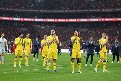 Romania's players applaud to supporters at the end of the 2026 World Cup playoff semifinal soccer match between Turkey and Romania, in Istanbul, Turkey.