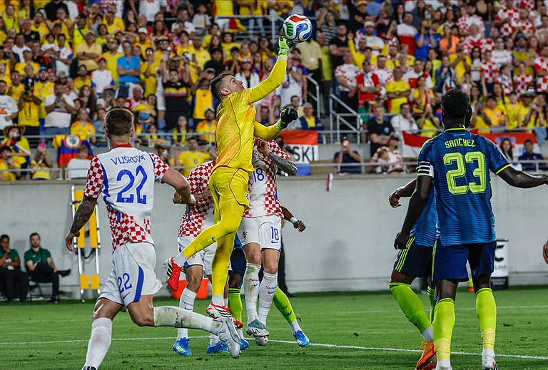 Croatia goalkeeper Dominik Livakovic, center, punches the ball away from the goal during the second half of an international friendly soccer game in Orlando, Florida. - | Photo: AP/Kevin Kolczynski