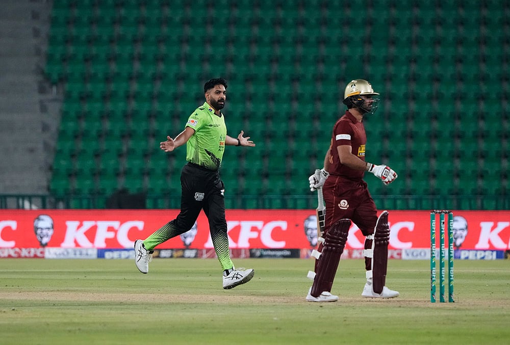 | Photo: AP/K.M. Chaudary : Lahore Qalandars' Haris Rauf, left, celebrates after taking the wicket of Hyderabad Kingsmen Hassan Khan, right, during the opening cricket match of the Pakistan Super League between Lahore Qalandars and Hyderabad Kingsmen, which taking place without spectators, in Lahore, Pakistan.